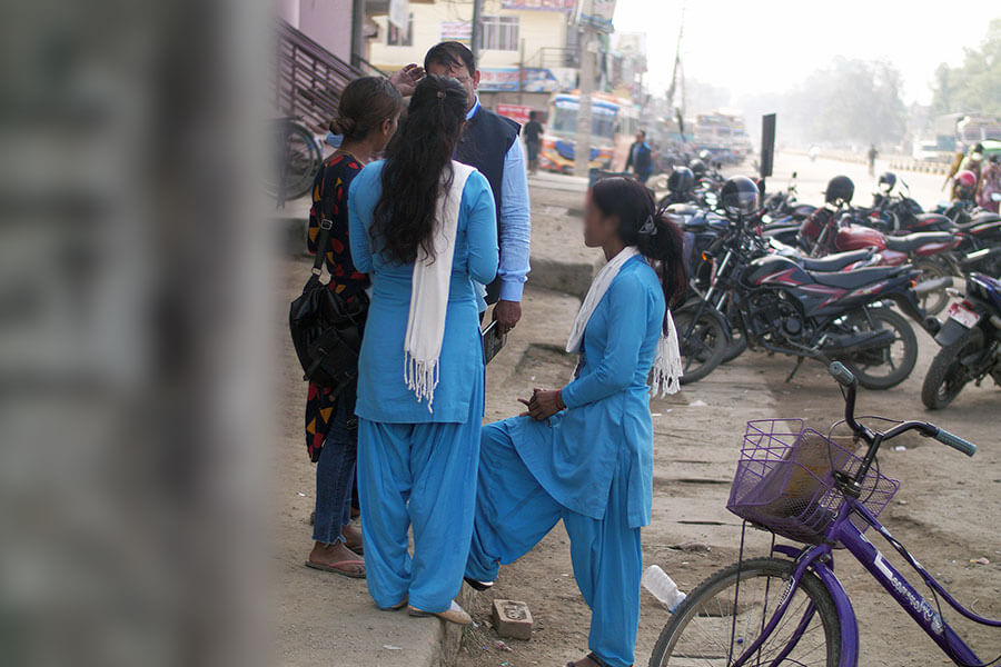 Border agents dressed vibrantly in blue working near the Nepal border