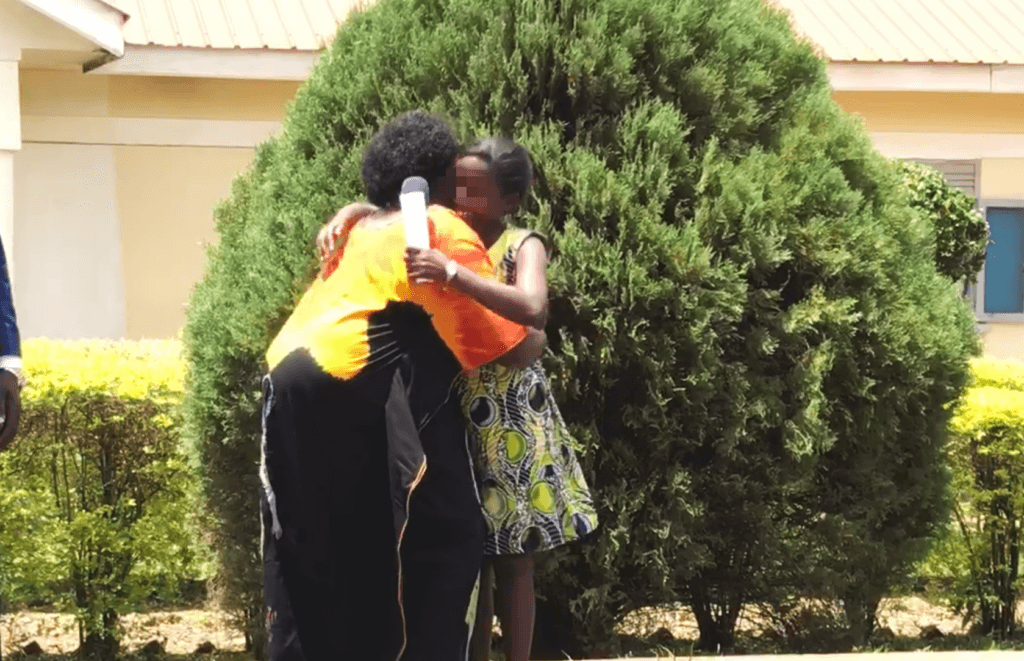 Staff mama hugs brave graduate
