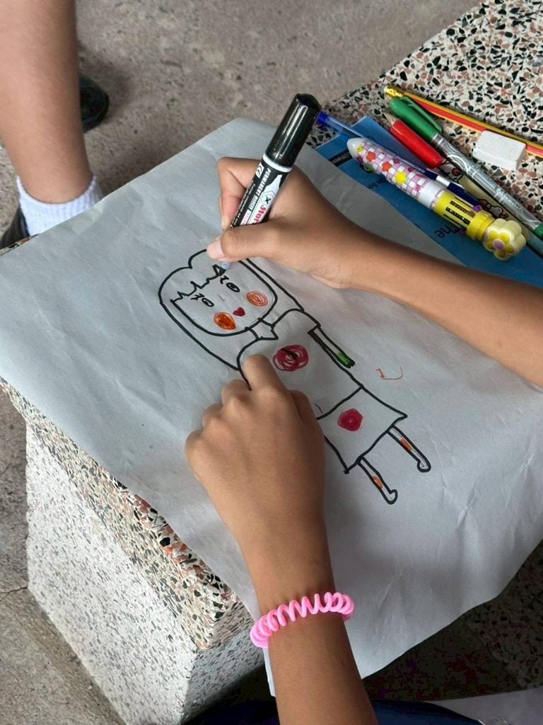 A child in Thailand completes an activity led by our team on safe touch